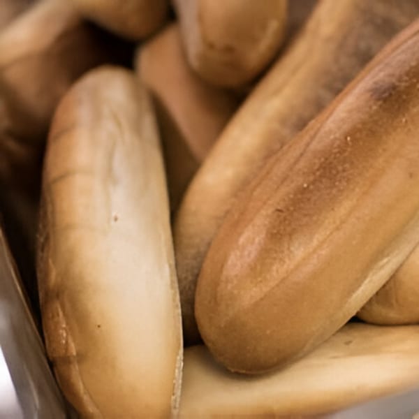 Close-up of freshly baked, golden-brown deli bread rolls, ready for sandwiches.