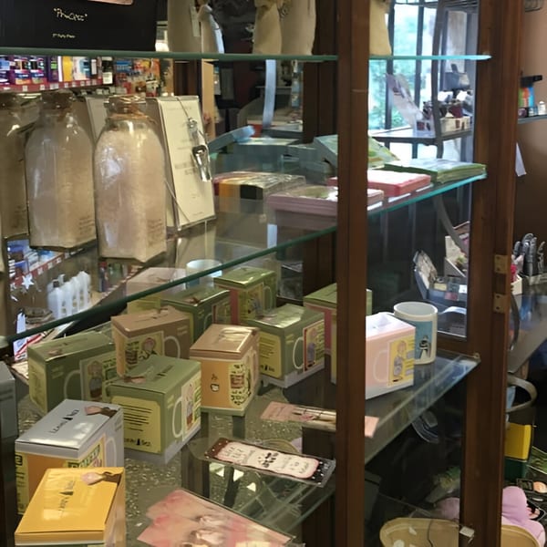 Glass display case at Ana's Corner Store filled with deli products and merchandise.
