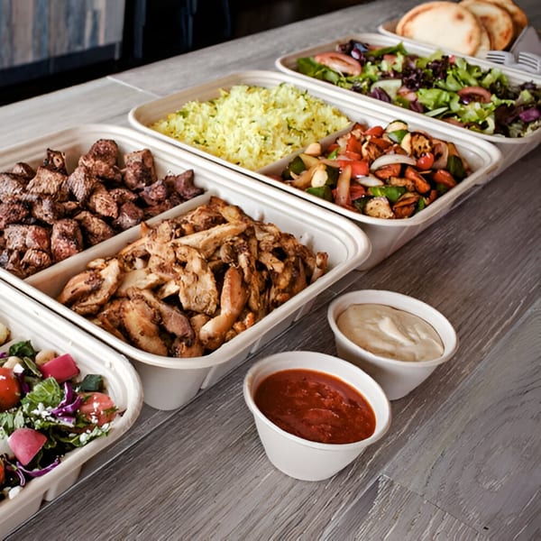 Ana's Corner Store deli spread with meats, rice, grilled vegetables, salads, and sauces.